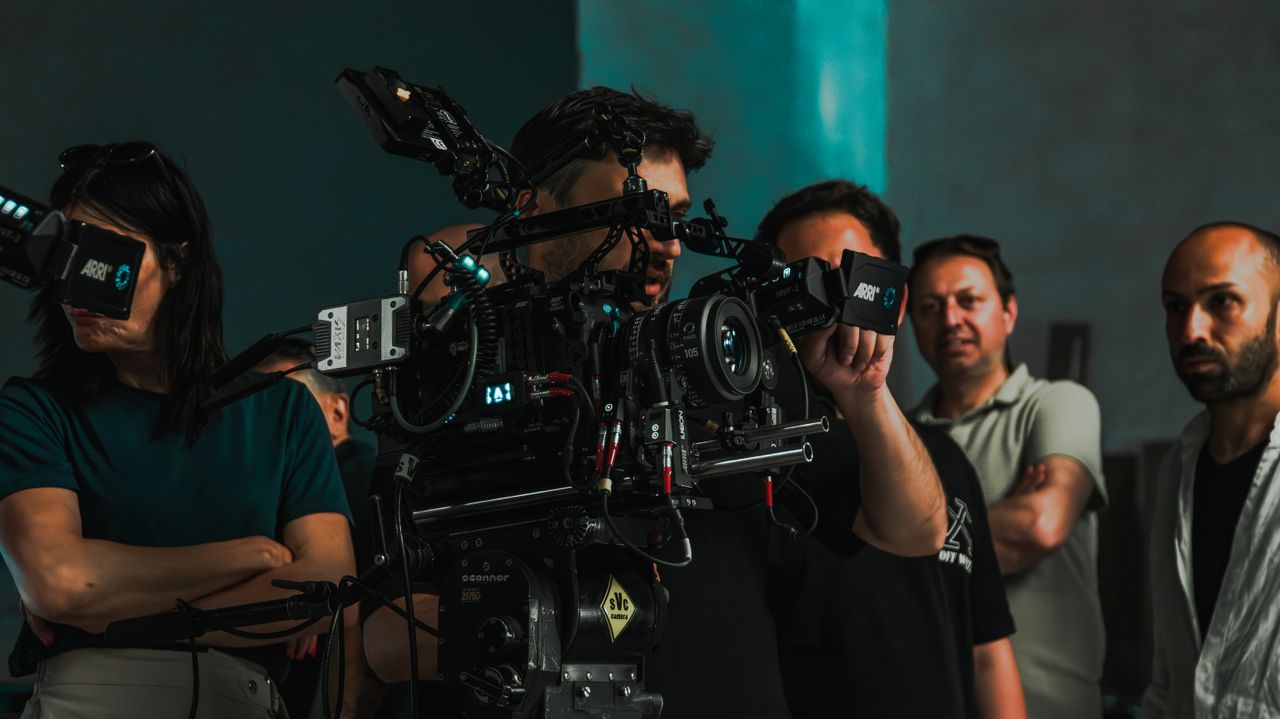 Film crew operating advanced cinema equipment on a set in Istanbul, showcasing teamwork.